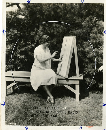 Helen Keller "Listening" to the Radio with Her Hand