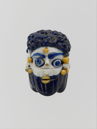 Glass face bead (Phoenician or Carthaginian circa mid-4th–3rd century BCE)