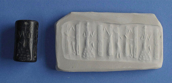 Cylinder seal of schist and six casts, featuring sun god Shamash stepping on a mountain with rays or streams issuing from his shoulders, between gates held by porters (Akkadian circa 24th-22nd century