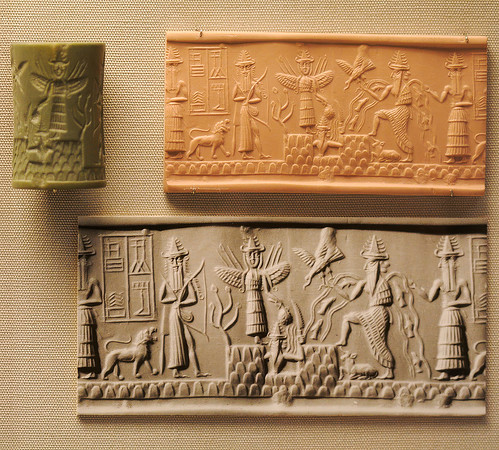 Cylinder seal from Sippar depicting Shamash with rays rising from his shoulders and holding a saw-toothed knife with which he cuts his way through the mountains of the east at dawn (circa 2300 BC)