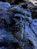 Sleeping Merlin sculpture at Merlin's Cave, Tintagel