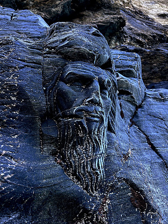 Sleeping Merlin sculpture at Merlin's Cave, Tintagel